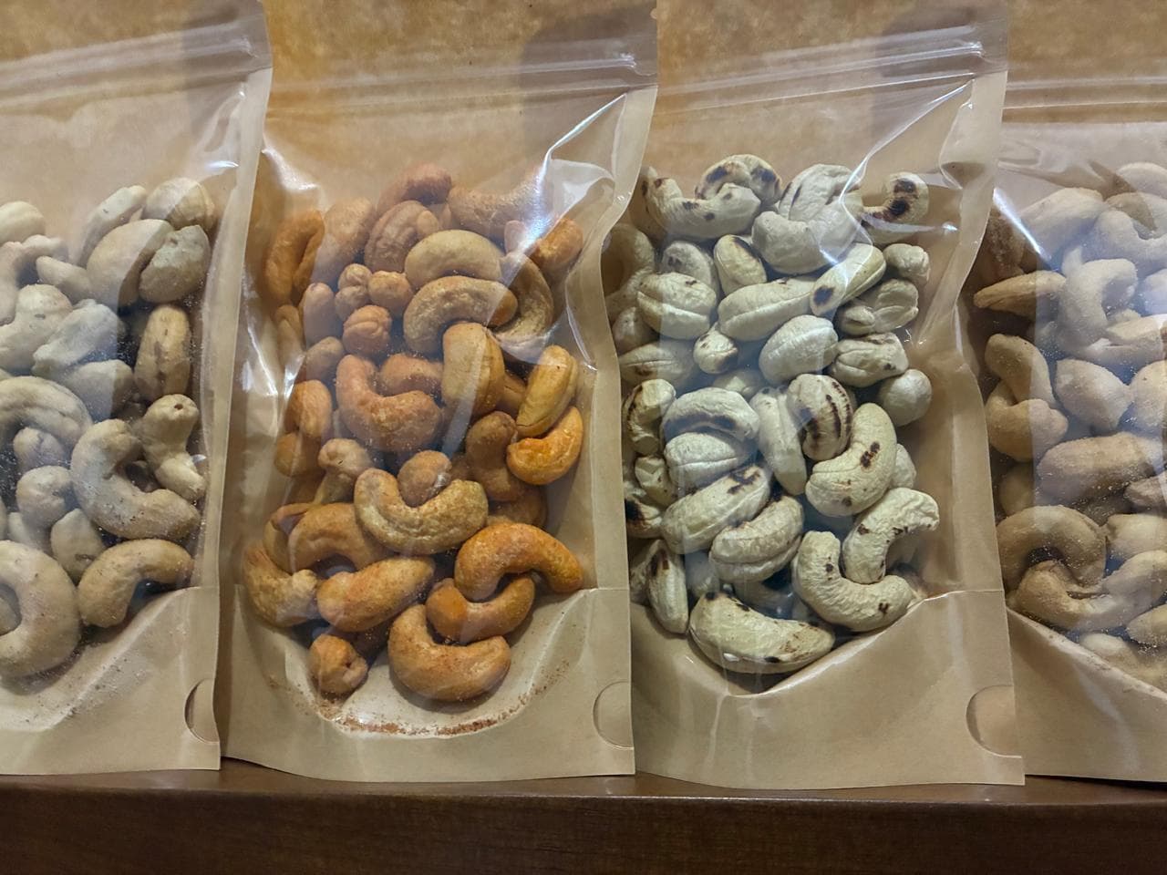 Bags of Kajuwa cashews, roasted, honey glazed, and plain, packed and ready to ship